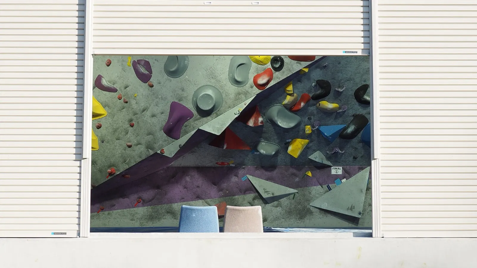 A climbing wall: five rungs, with the bottom ones set easier.