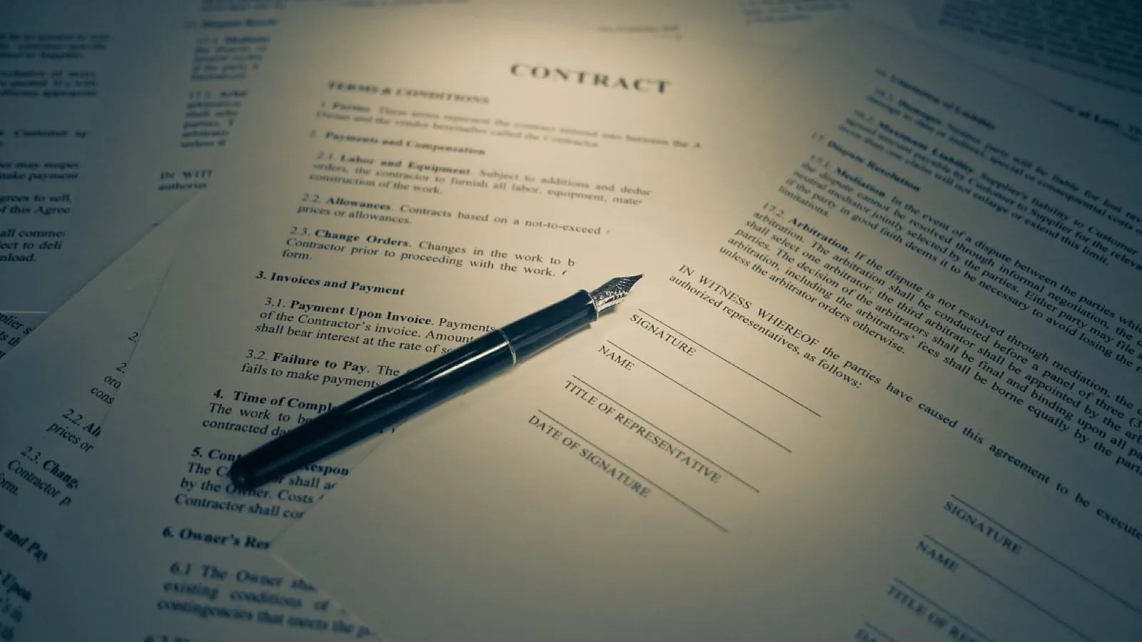 A pile of written work, the part no machine can assess.