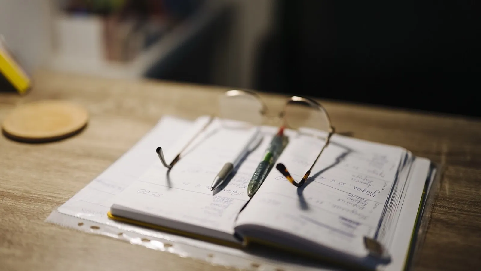 A paper notebook beside a laptop, each better at a different job.