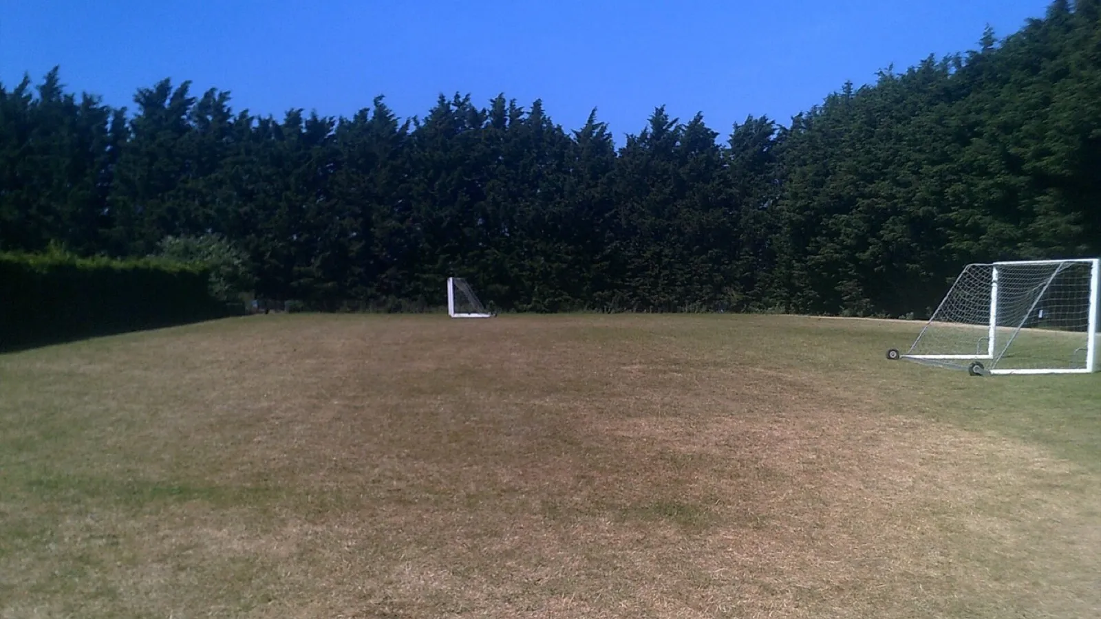 A marked sports pitch: the painted line is its perimeter, the grass inside is its area. Photo: Geographer, CC BY-SA 2.0, via Wikimedia Commons.